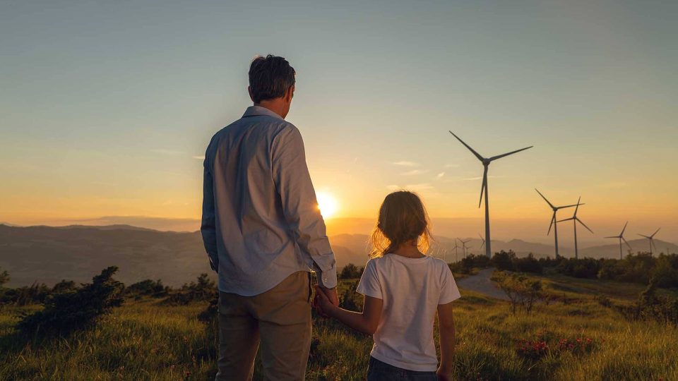 A father and son looking at air turbines